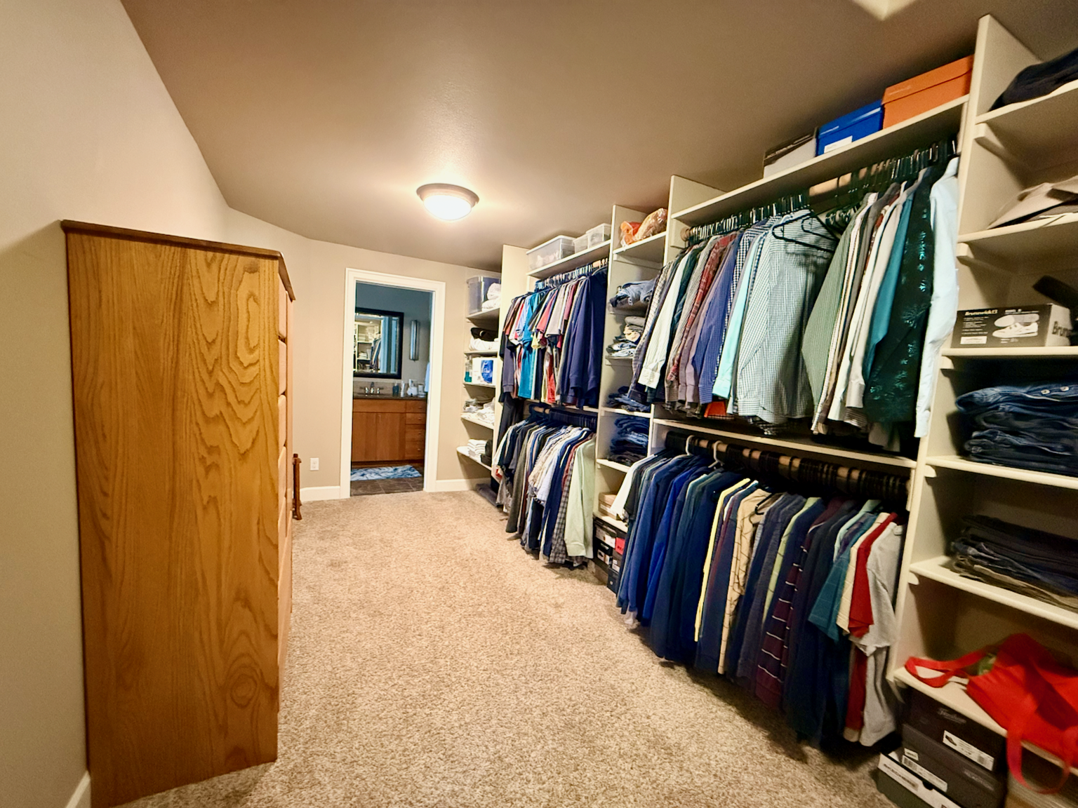 Primary closet with door to primary bathroom